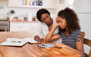 Mother Helps Stressed Teenage Daughter With Homework