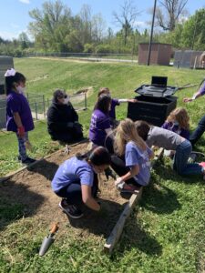 Students helping to clean up garden