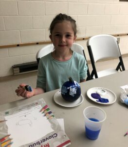 child working on craft