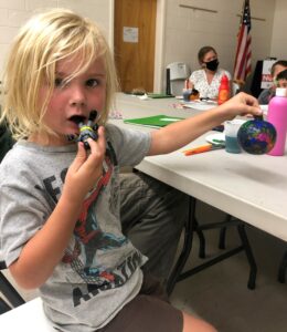 child showing craft work