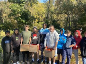 Students with boxes of produce.