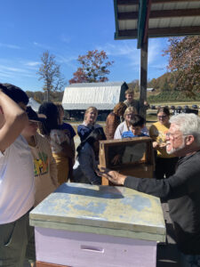 A beekeeper shows a frame from a bee hive.