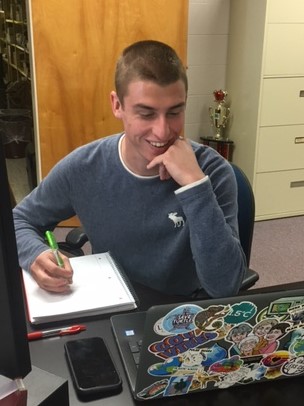 Issac Wyatt sitting at his desk.