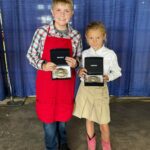 Two children pose with awards