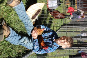 4-H Youth holding a hen and rooster
