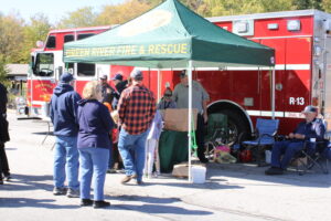 Adults speak to firefighters at the Green River Fire & Rescue tent.