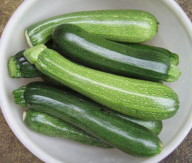 A bunch of zucchini in a bowl.