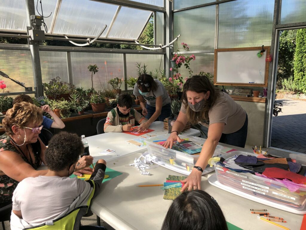 Children work with adults to create crafts.