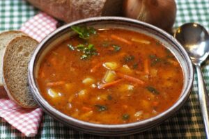 Vegetable soup with a side of bread.