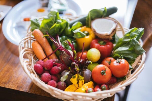 bowl of fresh fruits and vegetables on table